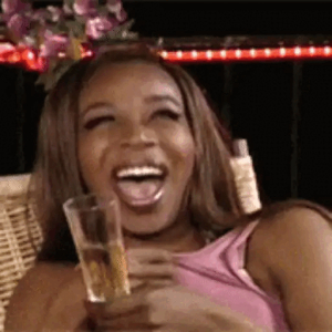 Laughing with a drink