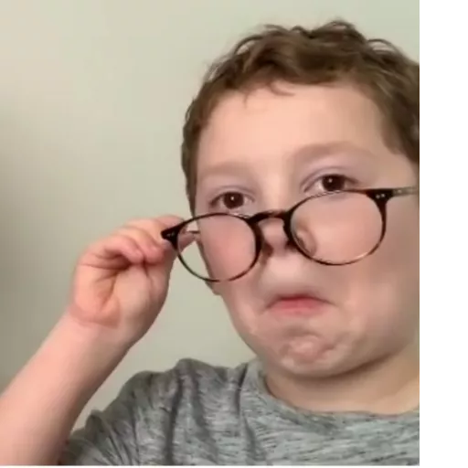 Kid adjusting glasses with skepticism